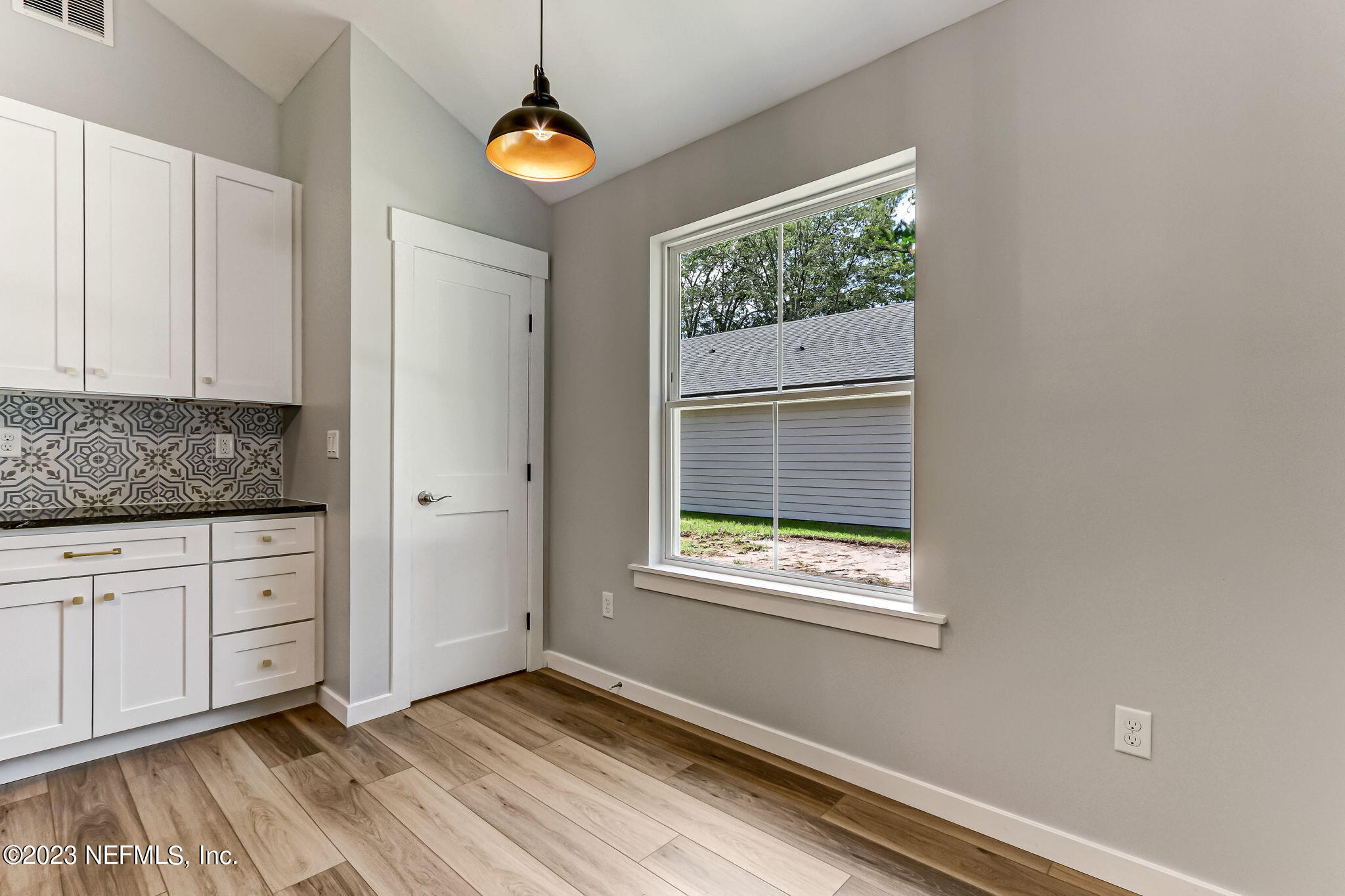 45115 South Mickler Street Callahan, FL 32011 - Photo 11 of 24 a view of an empty room with wooden floor and a window