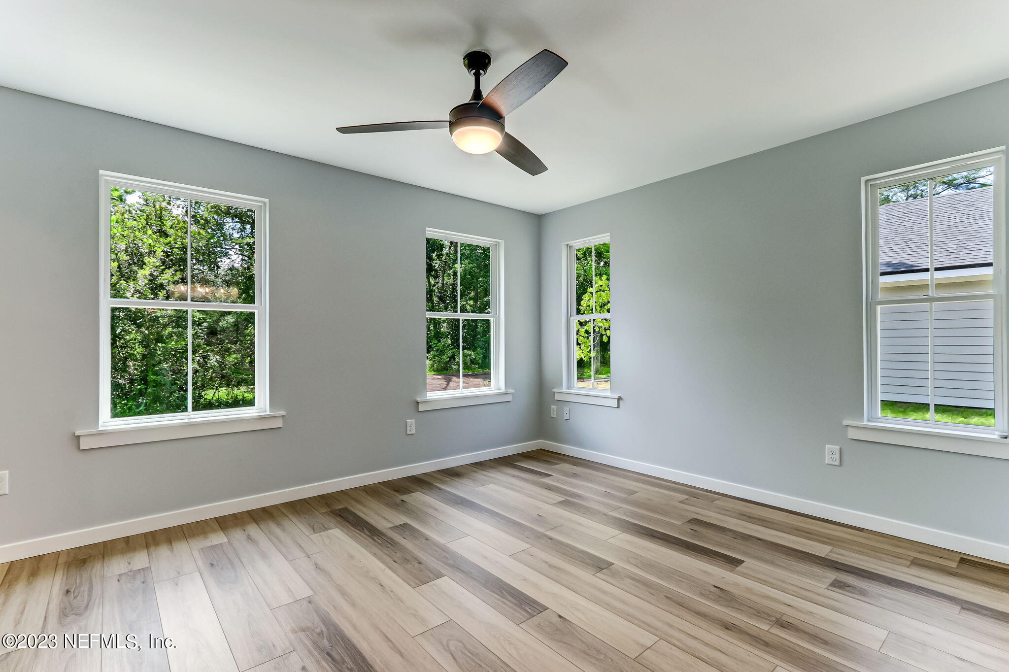 45115 South Mickler Street Callahan, FL 32011 - Photo 16 of 24 a view of empty room with wooden floor and fan