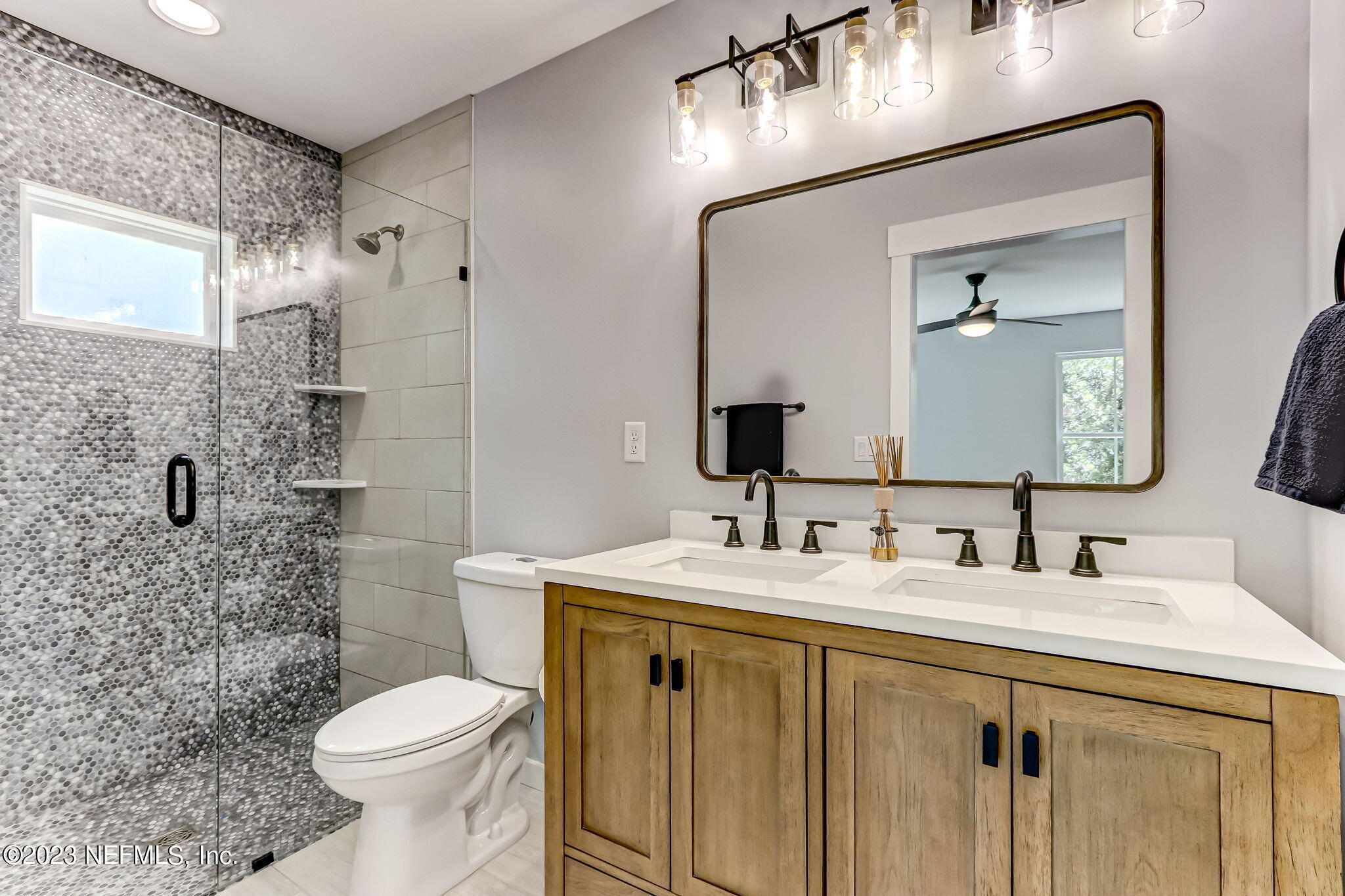 45115 South Mickler Street Callahan, FL 32011 - Photo 19 of 24 a bathroom with a toilet sink double vanity and mirror