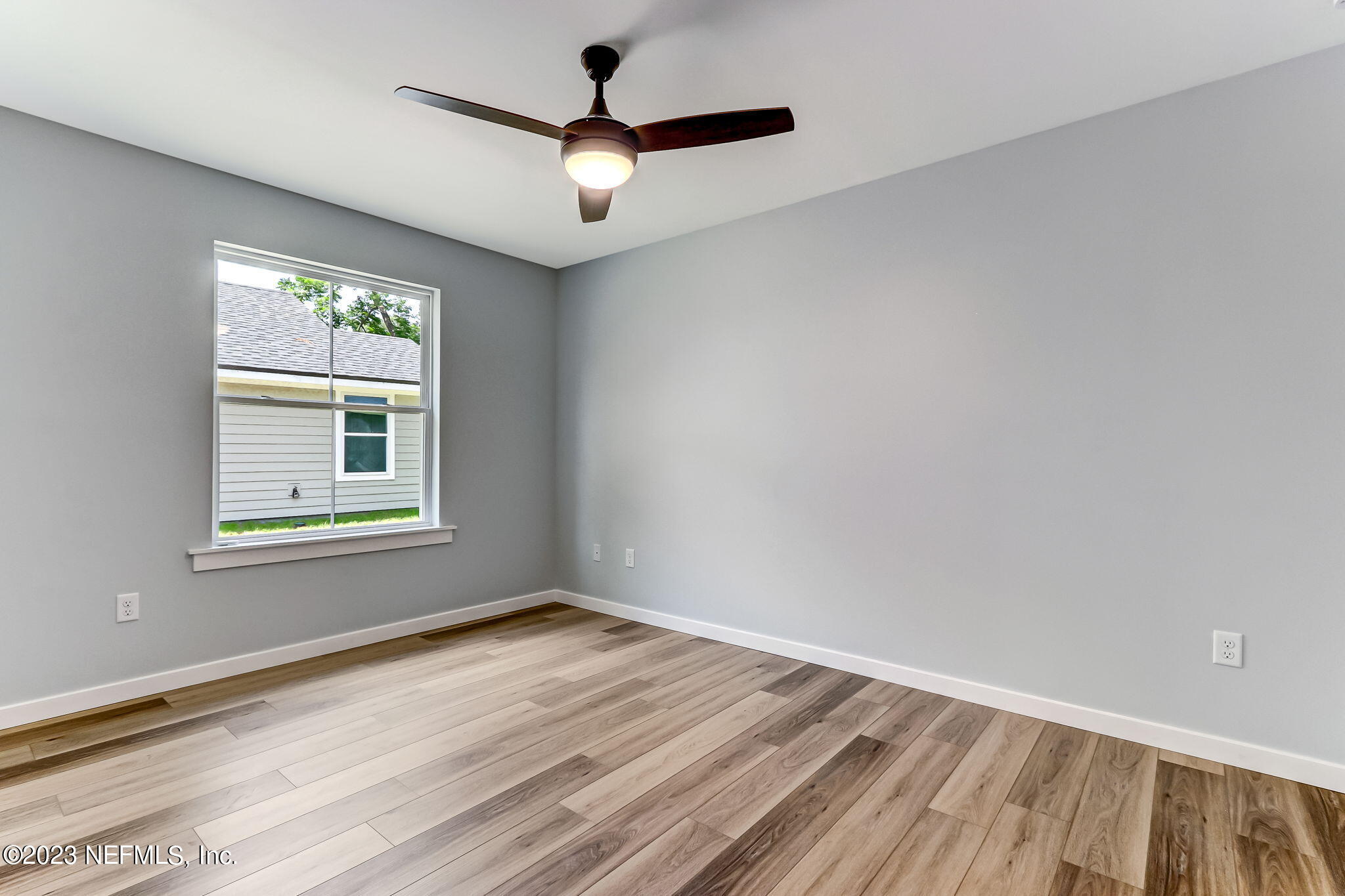 45115 South Mickler Street Callahan, FL 32011 - Photo 20 of 24 an empty room with a window and a ceiling fan