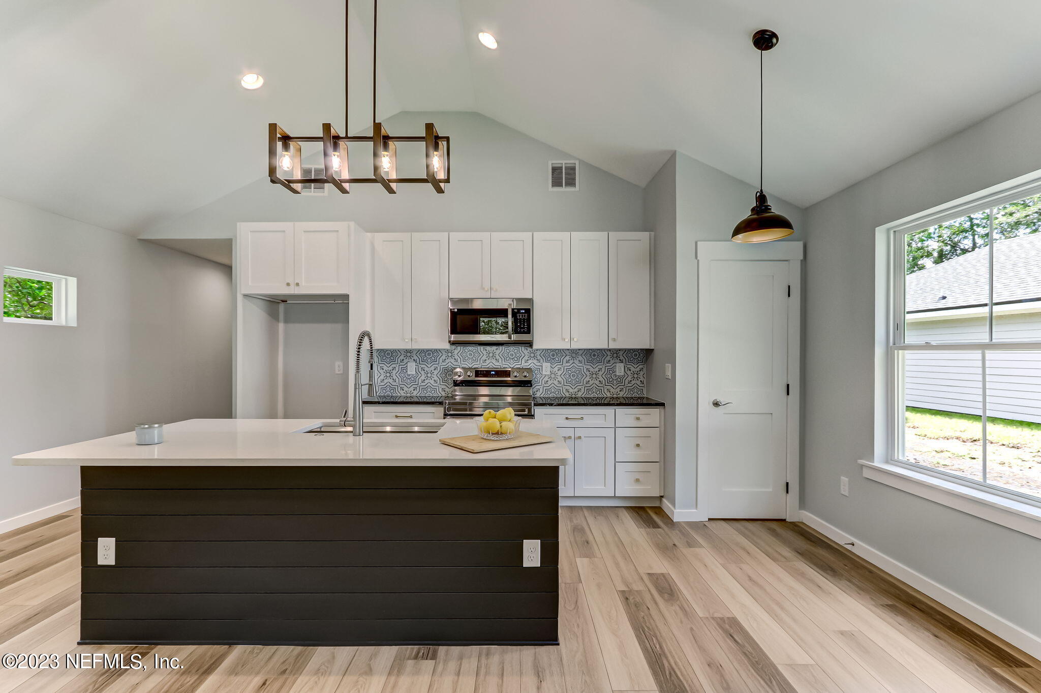 45115 South Mickler Street Callahan, FL 32011 - Photo 8 of 24 a kitchen with kitchen island a sink stainless steel appliances and cabinets