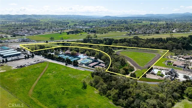 an aerial view of a house with a yard and lake view