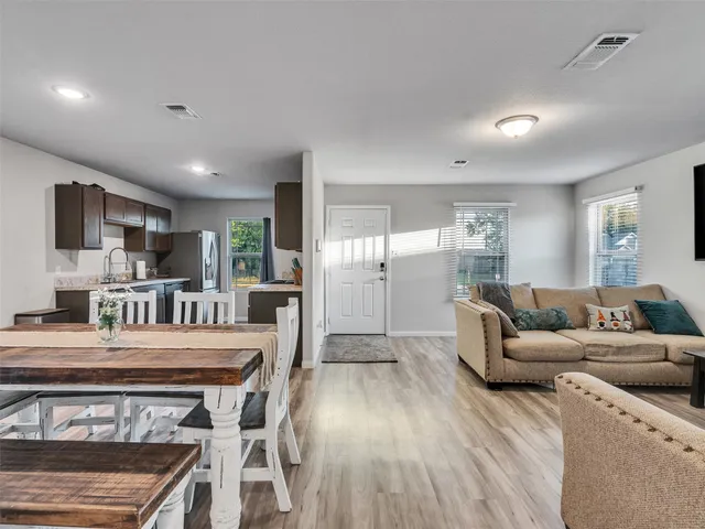a living room with stainless steel appliances kitchen island granite countertop furniture and a kitchen view