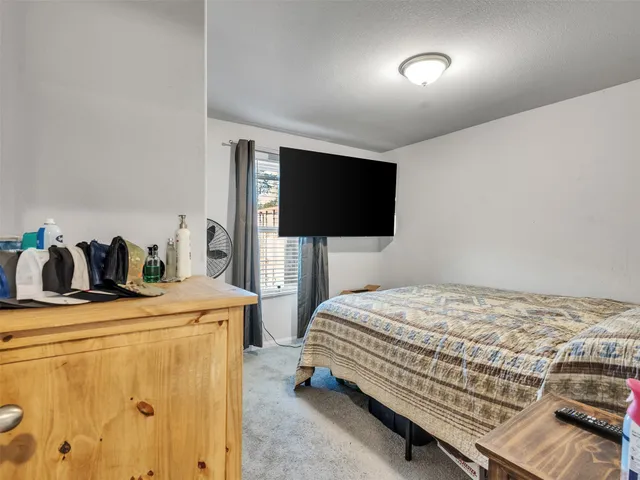 a bedroom with a bed and a lamp