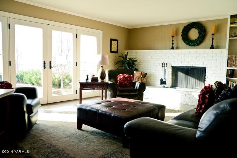 1102 Hillman Road Yakima, WA 98908 - Photo 7 of 49 a living room with furniture a large window and a fireplace