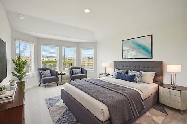 a bedroom with bed and large windows