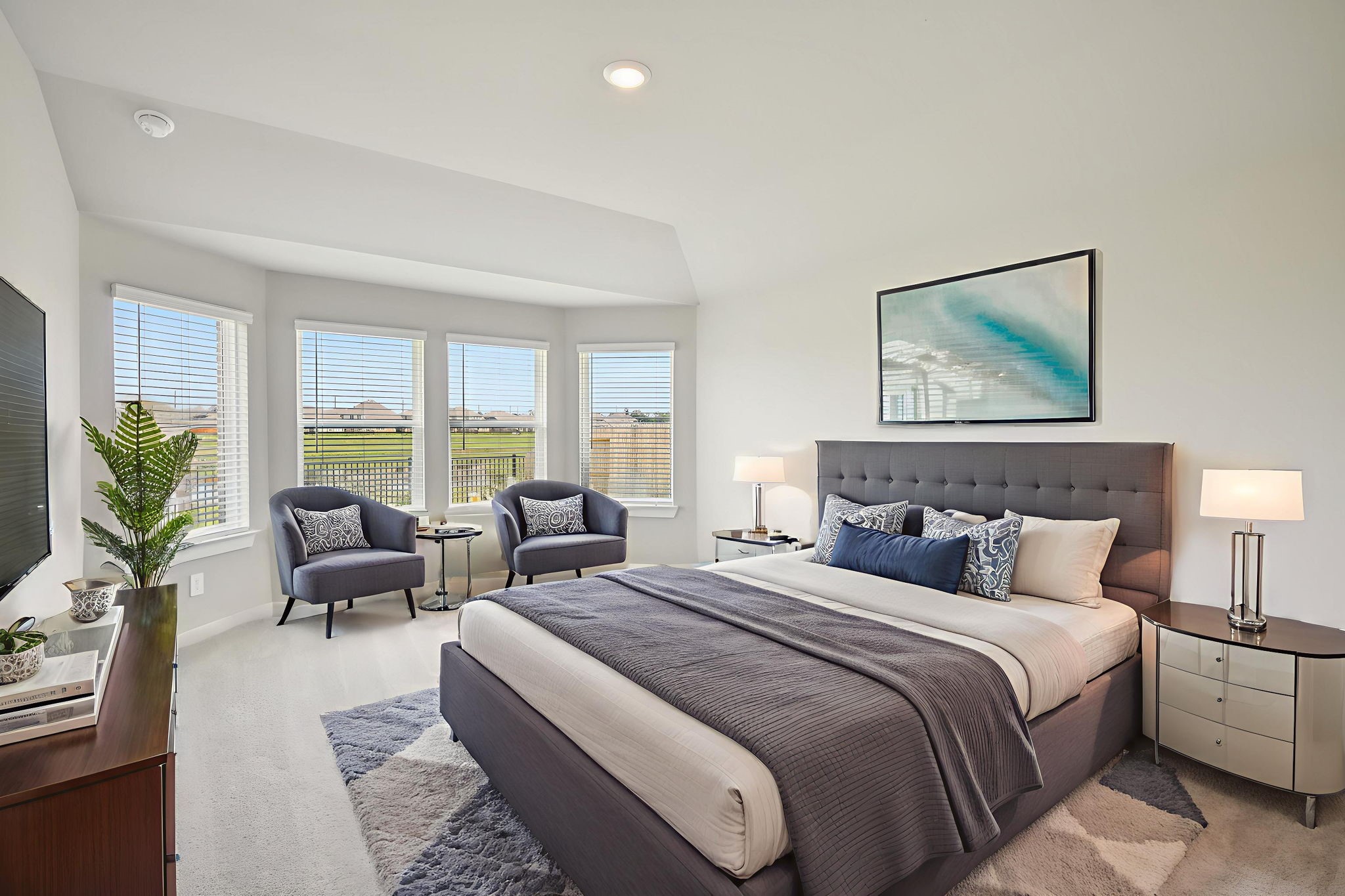 a bedroom with bed and large windows