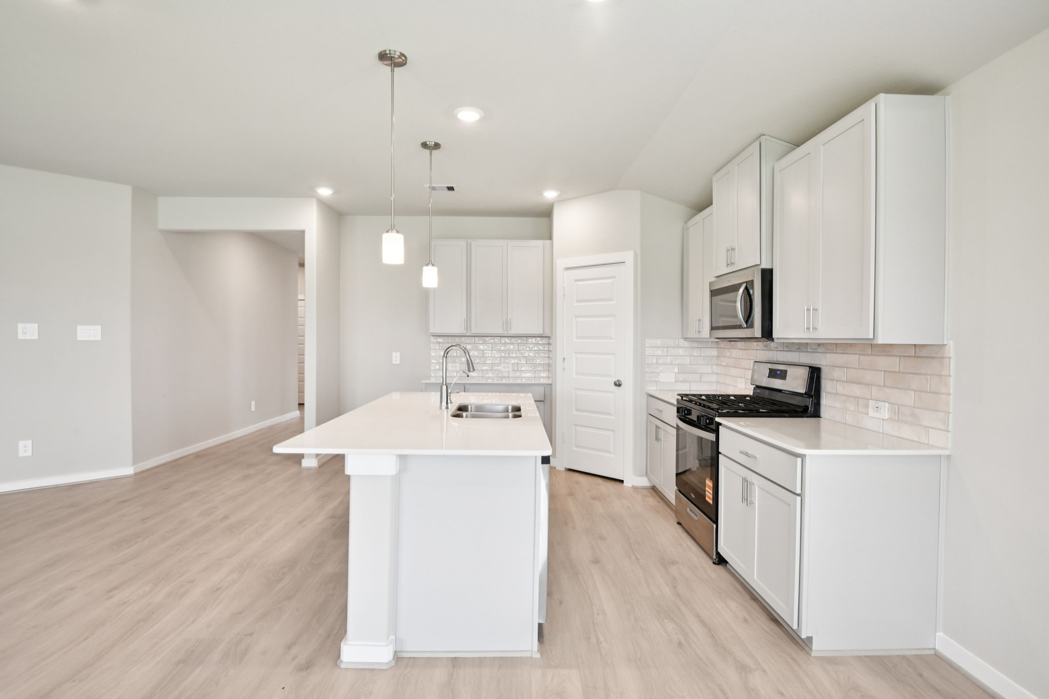 5814 Chamberlain Crossing Rosenberg, TX 77471 - Photo 7 of 39 a kitchen with a sink stove top oven and cabinets