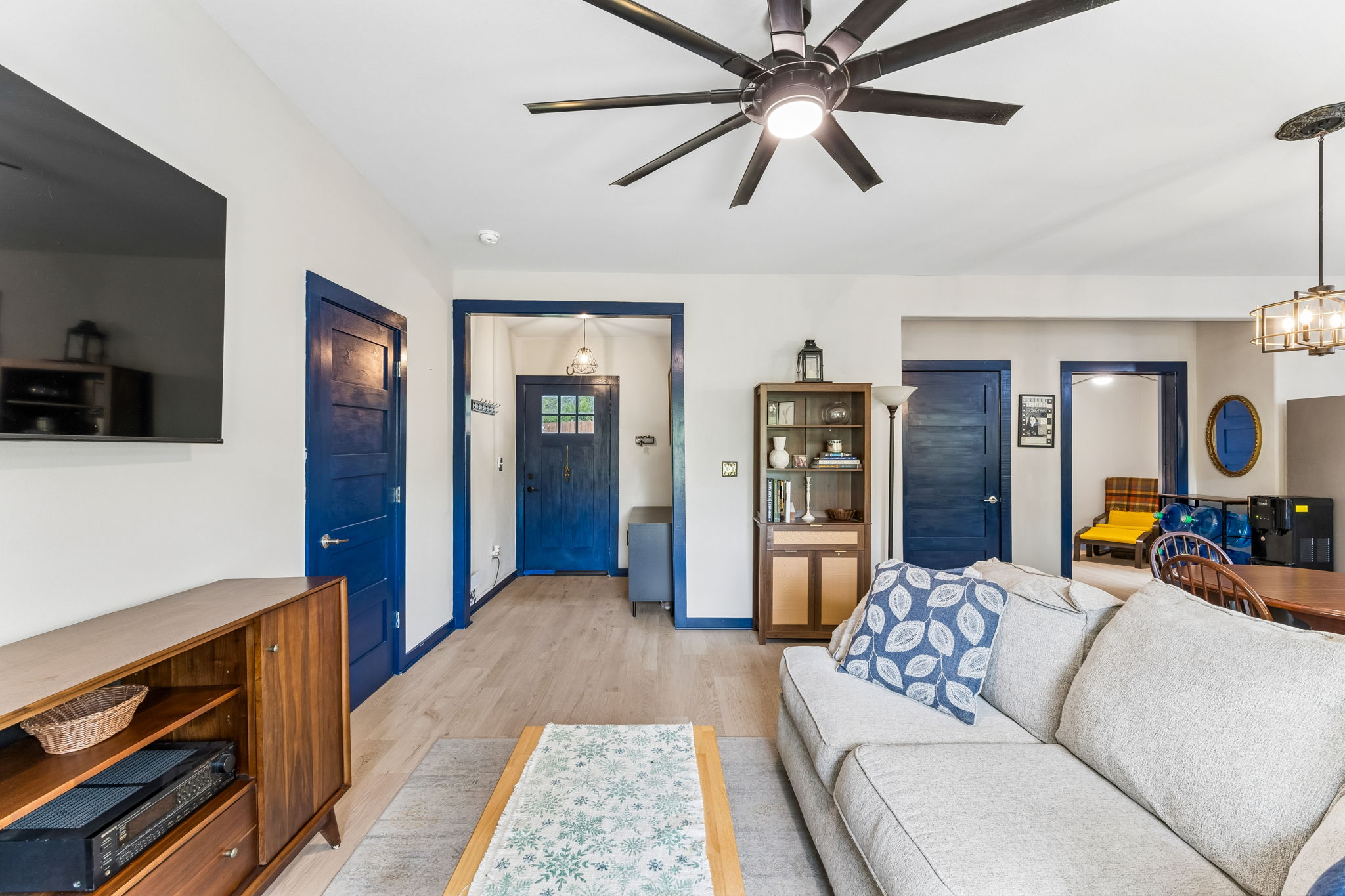 2240 Fm 3237 Road Wimberley, TX 78676 - Photo 8 of 26 This living area features light-colored flooring, white walls, and blue trim around doors and entryways