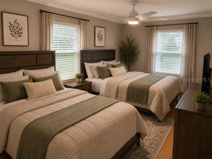 1623 Wavecrest Street Merritt Island, FL 32952 - Photo 20 of 26 a bedroom with two beds and a flat screen tv