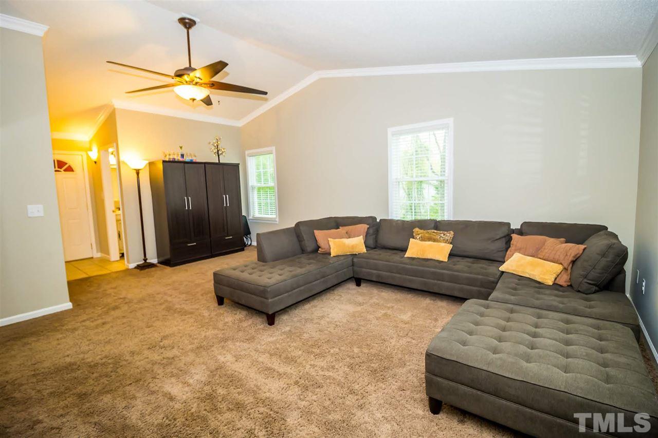 2009 Messer Road Raleigh, NC 27603 - Photo 14 of 30 a living room with furniture and a chandelier