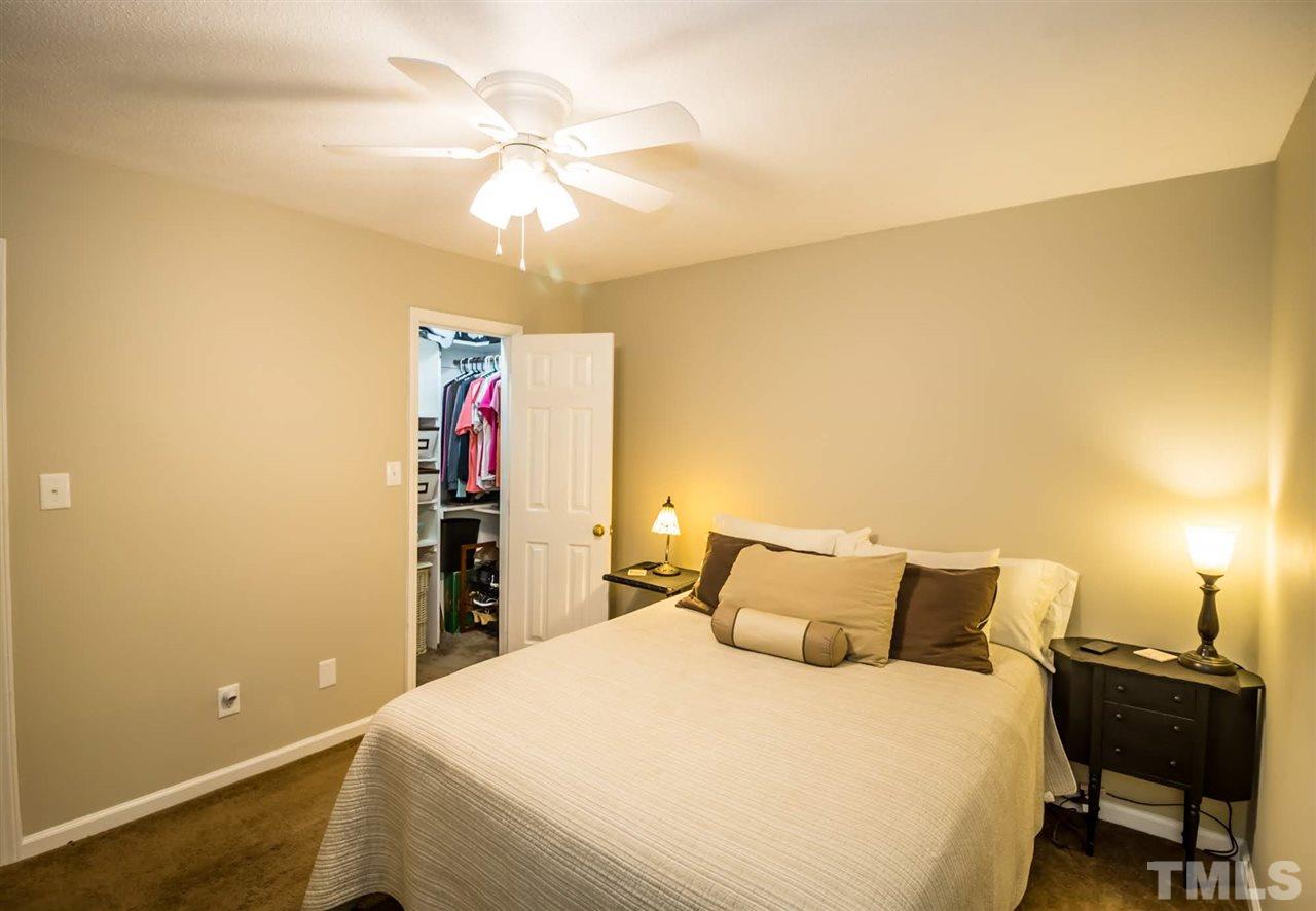 2009 Messer Road Raleigh, NC 27603 - Photo 22 of 30 a bedroom with a bed and a chandelier