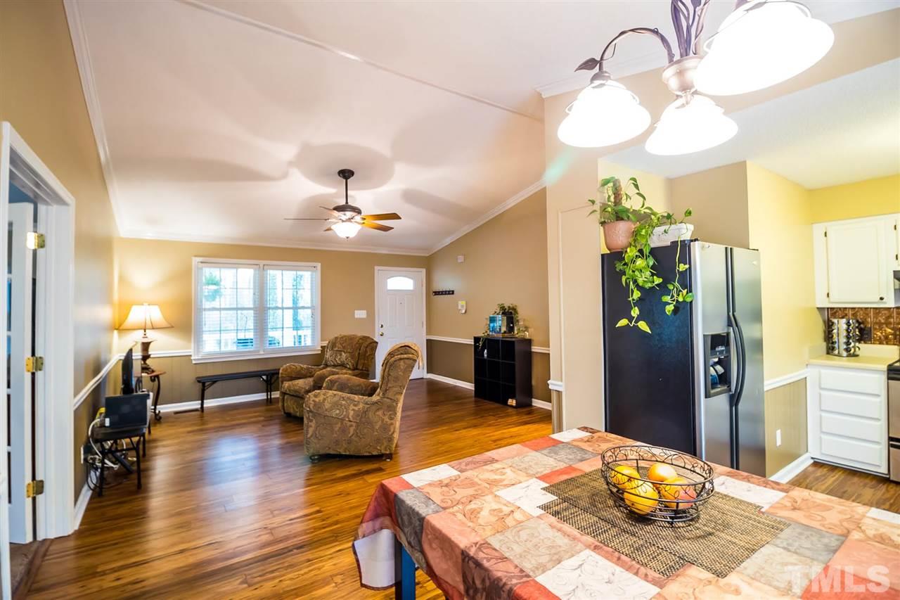 2009 Messer Road Raleigh, NC 27603 - Photo 10 of 30 a living room with furniture a chandelier and a dining table