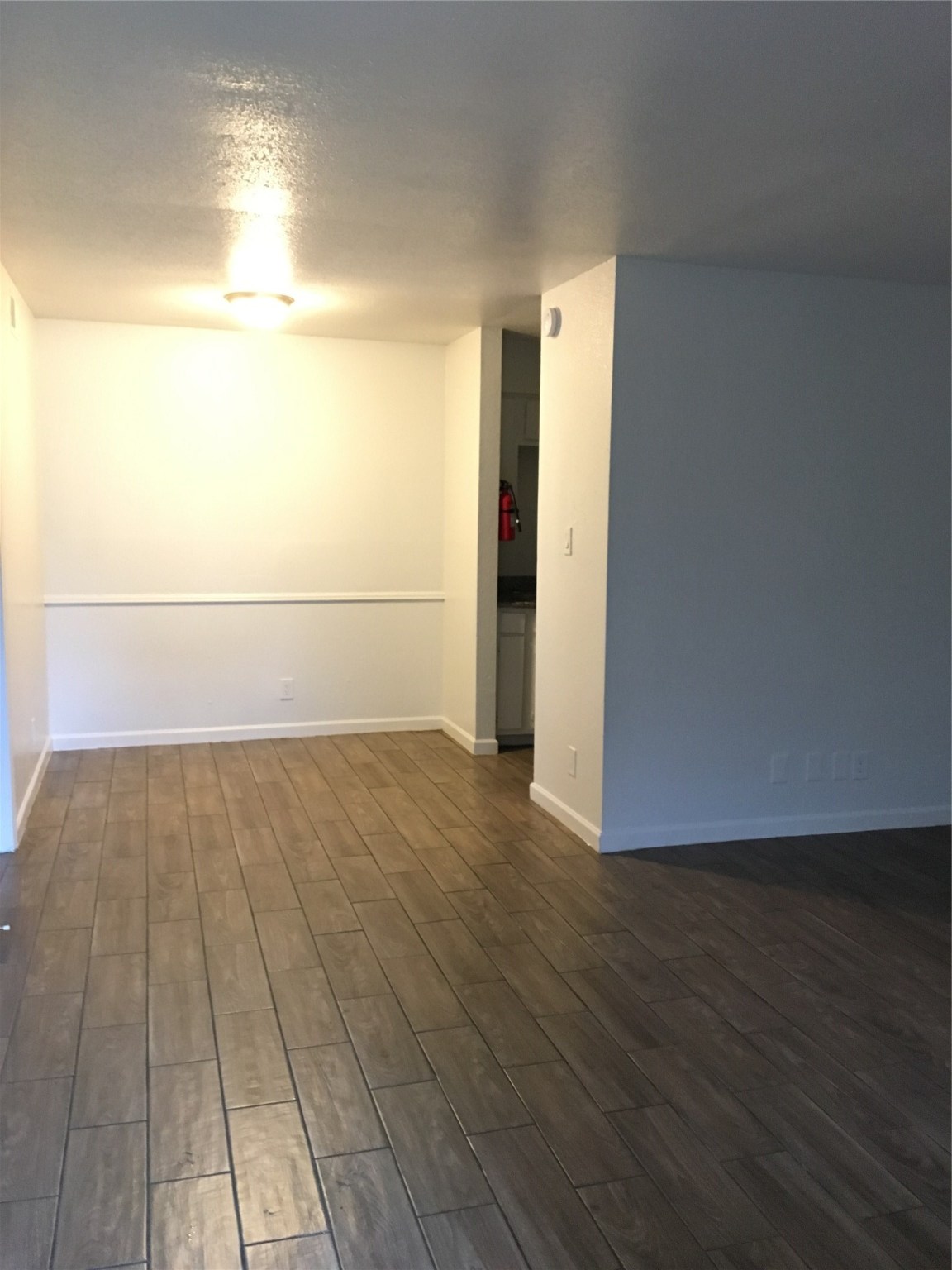 6200 West Tidwell Road, Unit 1615 Houston, TX 77092 - Photo 3 of 8 an empty room with wooden floor