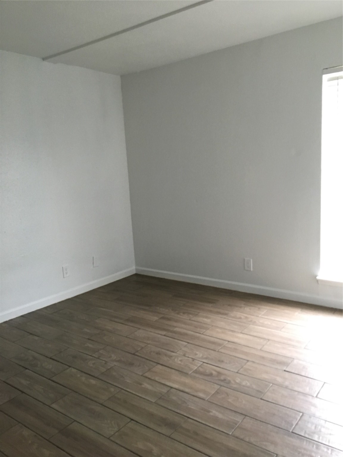 6200 West Tidwell Road, Unit 1615 Houston, TX 77092 - Photo 4 of 8 a view of an empty room and wooden floor