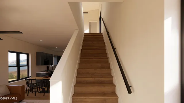 a view of entryway and hall with wooden floor