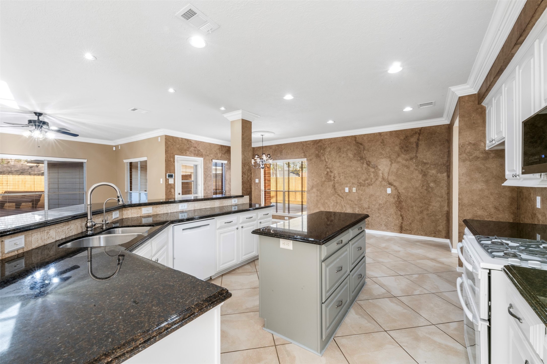 2406 Spanish Oak Hill Court Spring, TX 77388 - Photo 15 of 44 a kitchen with granite countertop a sink and a stove top oven