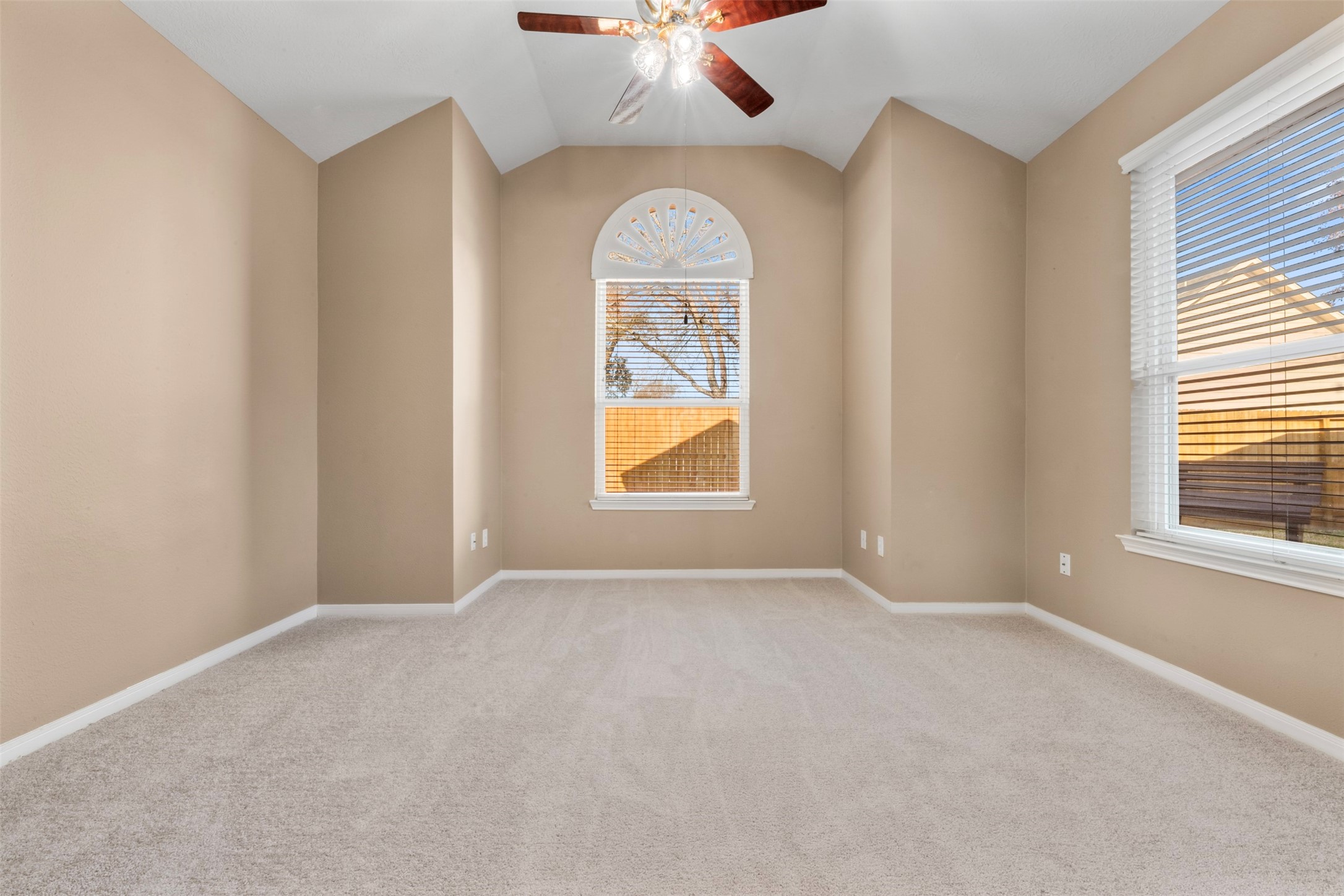 2406 Spanish Oak Hill Court Spring, TX 77388 - Photo 20 of 44 an empty room with window chandelier fan and windows