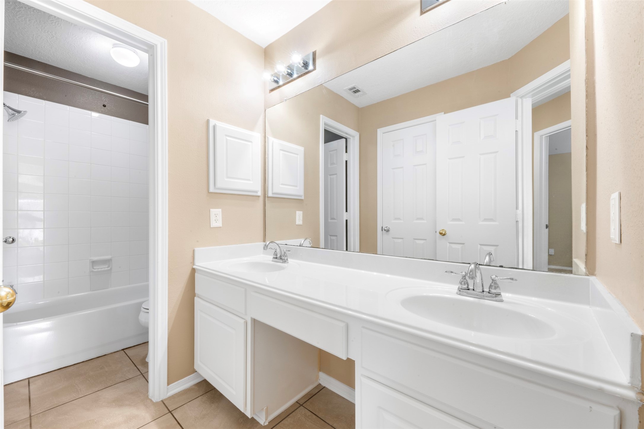 2406 Spanish Oak Hill Court Spring, TX 77388 - Photo 30 of 44 a bathroom with a sink double vanity granite tub shower and a mirror