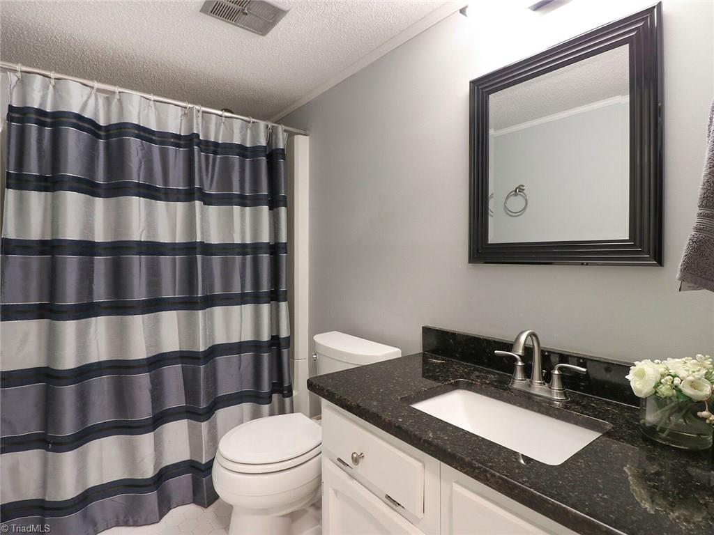 540 Lindley Road Greensboro, NC 27410 - Photo 22 of 29 Even the lower level bath has been updated.