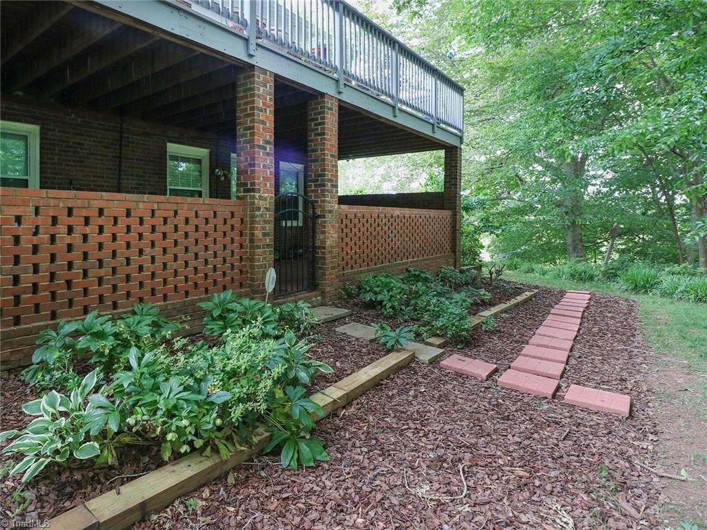 540 Lindley Road Greensboro, NC 27410 - Photo 29 of 29 Back view shows nice landscaping and a stepping stone walk.