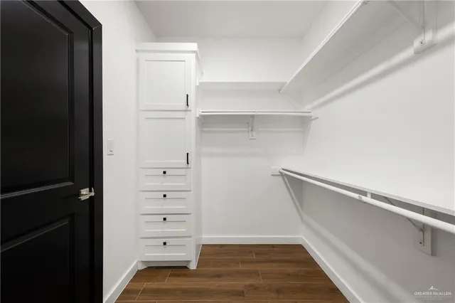 a view of walk in closet with empty racks