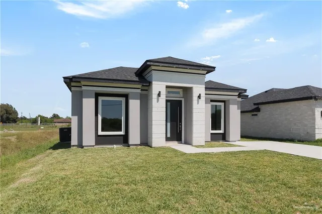a view of a house with wooden fence