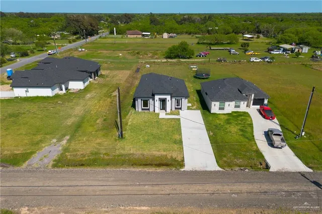 an aerial view of a house with a yard