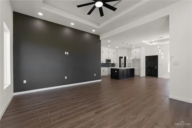 a view of a kitchen with a sink and stainless steel appliances