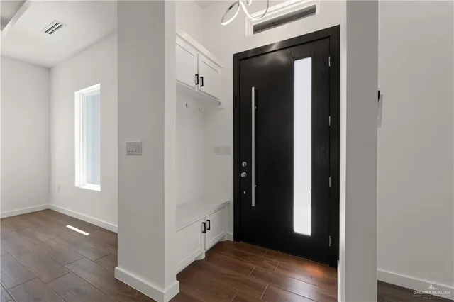 an empty room with wooden floor and closet
