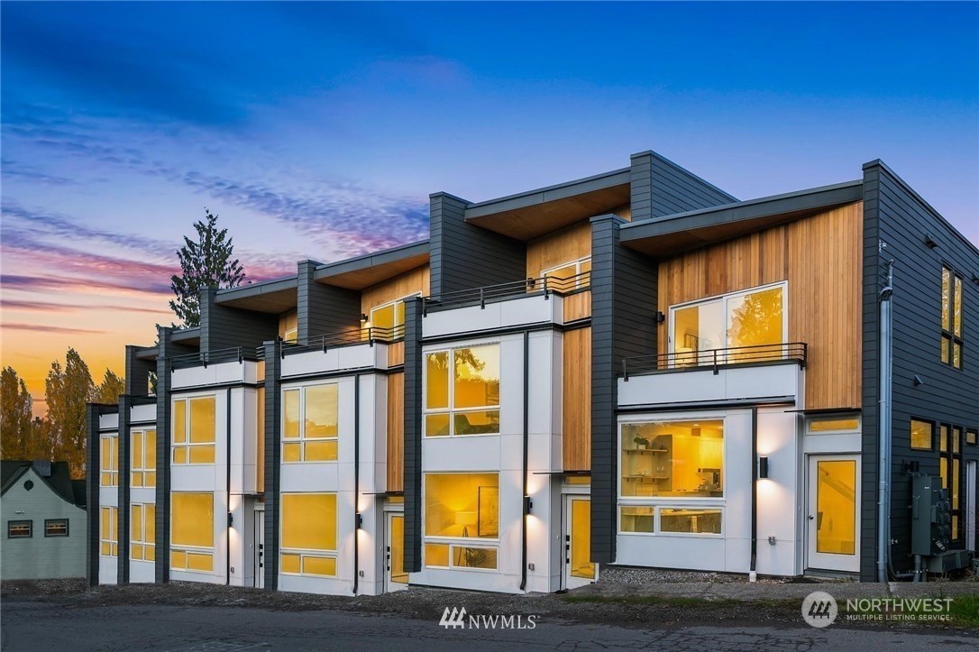 a view of a brick house with large windows