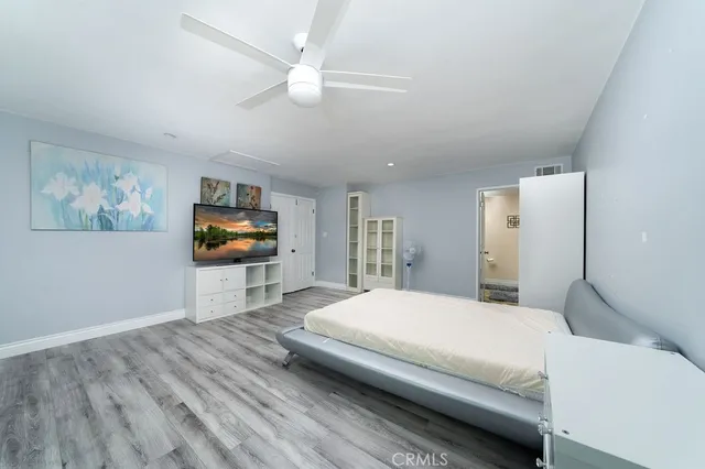 a bedroom with a bed and a flat screen tv