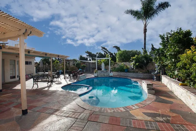a view of a swimming pool with sitting area