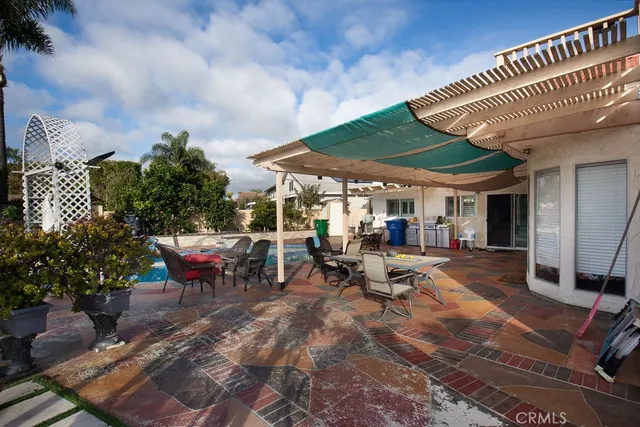 a view of a patio with table and chairs and potted plants