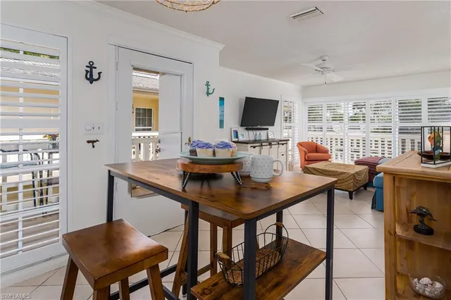 a view of a workspace with a table and chairs in a room