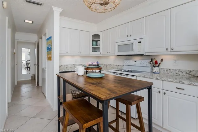 a kitchen that has a table and chairs in it