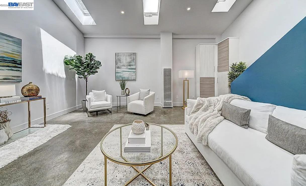 1451 13th Street, Unit 1 Oakland, CA 94607 - Photo 3 of 10 a living room with furniture and a potted plant
