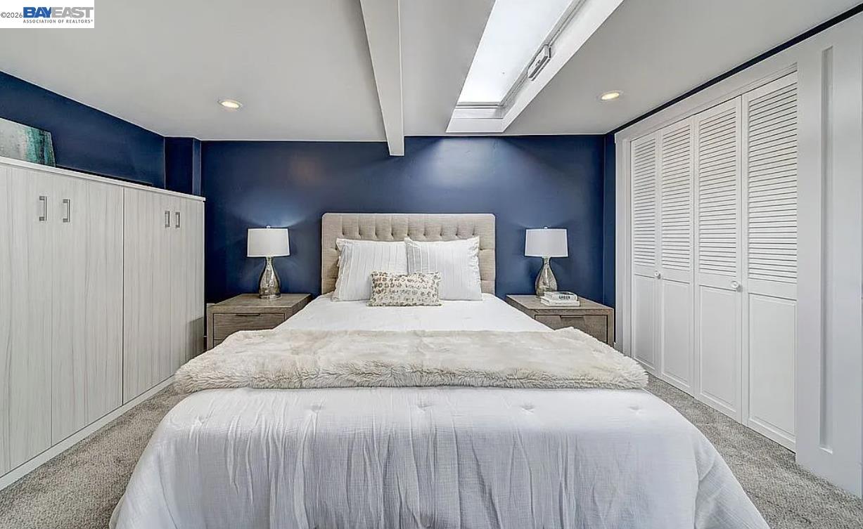 1451 13th Street, Unit 1 Oakland, CA 94607 - Photo 7 of 10 a bedroom with a bed and a refrigerator