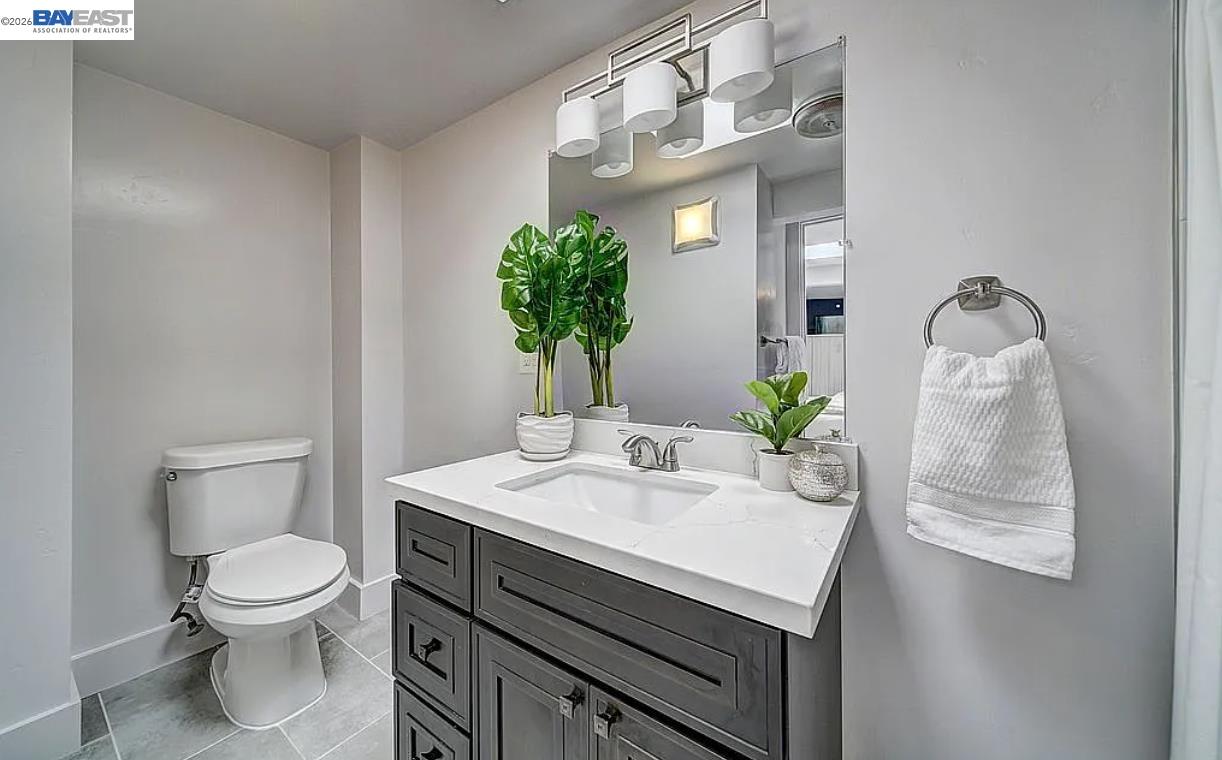 1451 13th Street, Unit 1 Oakland, CA 94607 - Photo 8 of 10 a view of bathroom with a toilet sink and mirror