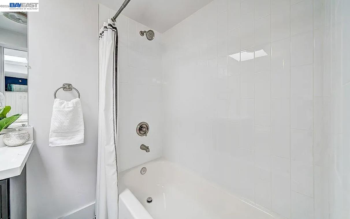 1451 13th Street, Unit 1 Oakland, CA 94607 - Photo 9 of 10 a bathroom with a bathtub a sink and a shower