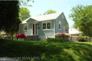 4409 Clearfield Road Silver Spring, MD 20906 - Photo 1 of 1 a front view of a house with a garden and yard