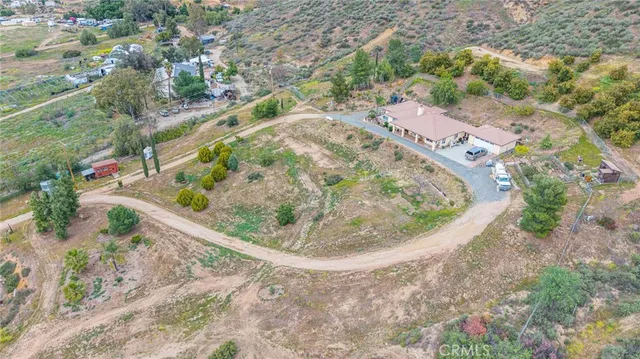 an aerial view of a swimming pool with outdoor seating