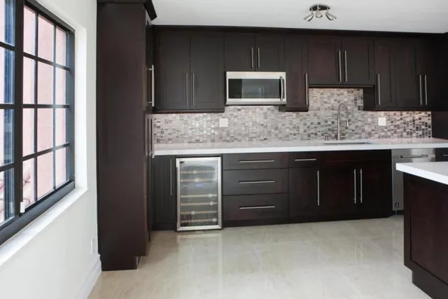 a kitchen with stainless steel appliances granite countertop a stove and a sink