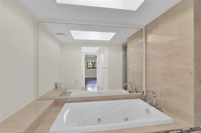 a bathroom with a bathtub and shower