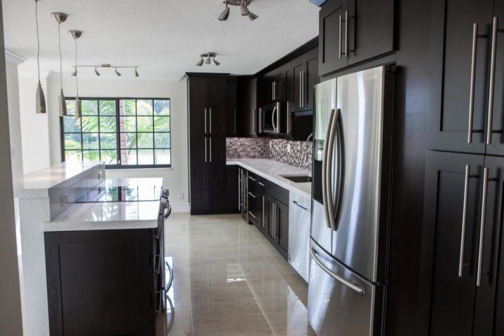250 East Royal Palm Road, Unit 2A Boca Raton, FL 33432 - Photo 3 of 26 a kitchen with stainless steel appliances granite countertop a refrigerator and a sink
