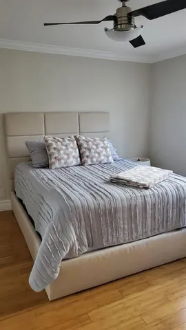 a bedroom with a bed and wooden floor