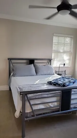 a bedroom with a bed and window