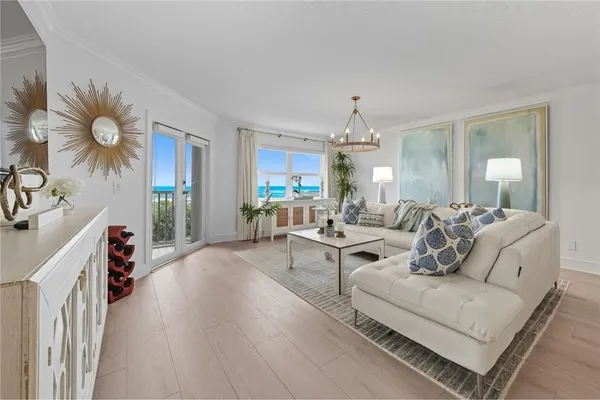 a living room with furniture and a chandelier