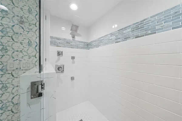 a bathroom with a double vanity sink mirror and shower