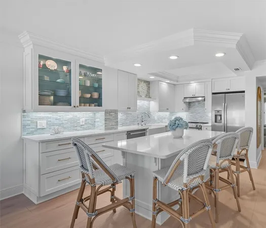 a dining hall with stainless steel appliances granite countertop a dining table and chairs